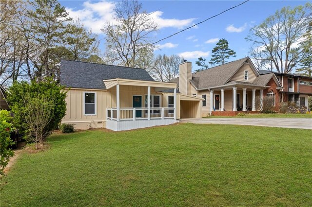 599 Daniel Ave, Decatur, GA 30032 - view of front of home with driveway, a front yard, a chimney, board and batten siding, and a shingled roof