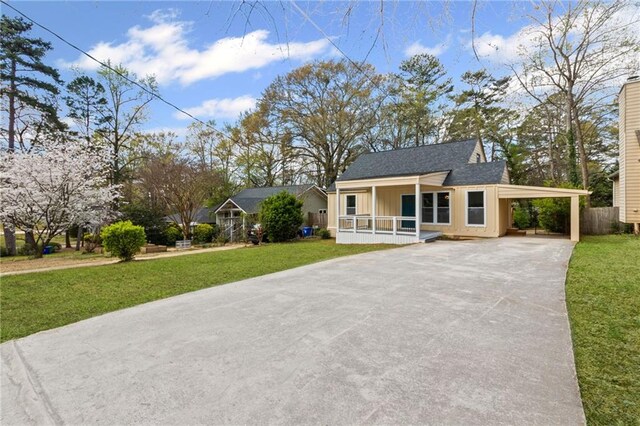 599 Daniel Ave, Decatur, GA 30032 - view of front of house with a front lawn, a carport, a porch, and concrete driveway