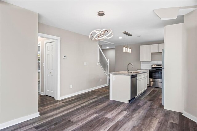 599 Daniel Ave, Decatur, GA 30032 - kitchen with tasteful backsplash, an inviting chandelier, stainless steel appliances, dark wood-type flooring, and a sink