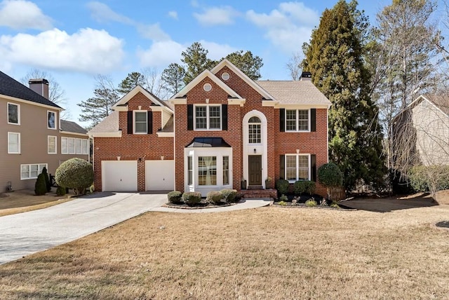 view of front of property with a chimney, a front lawn, concrete driveway, and brick siding