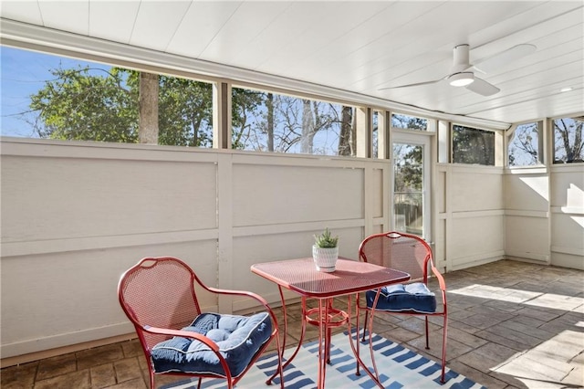 sunroom / solarium featuring wooden ceiling and ceiling fan