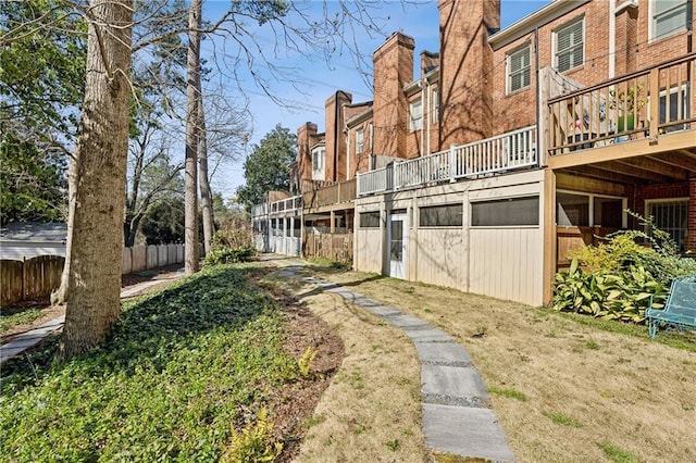 back of house featuring a residential view and fence