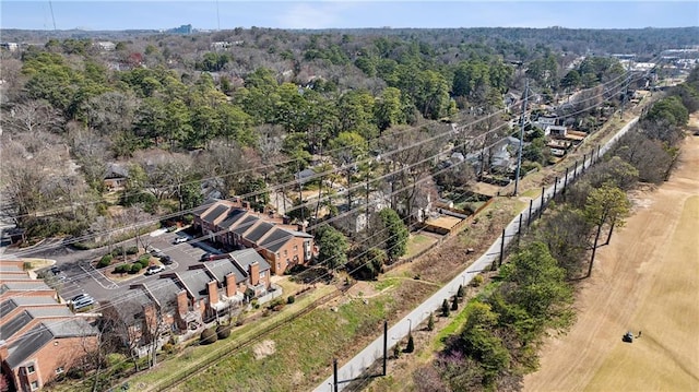 birds eye view of property featuring a wooded view