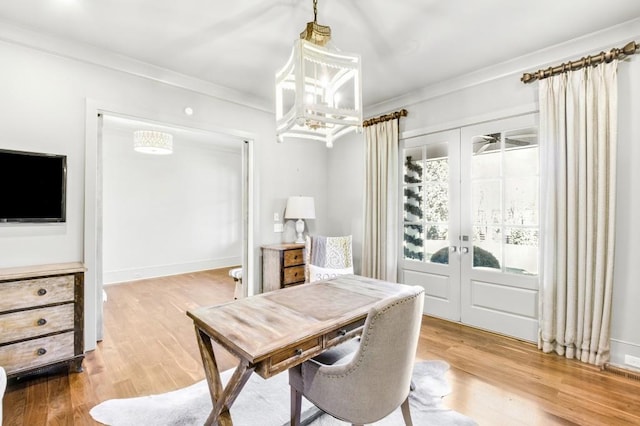 dining room with baseboards, french doors, wood finished floors, and crown molding