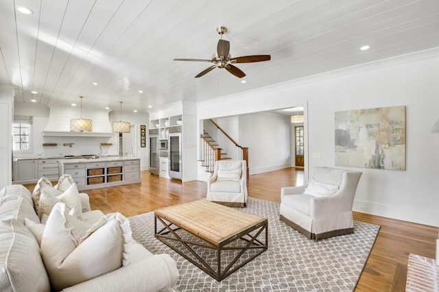 living area with baseboards, wooden ceiling, stairway, light wood-style floors, and recessed lighting