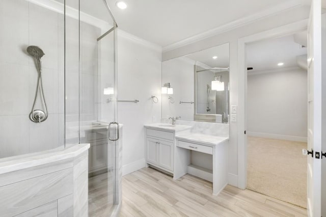 full bathroom featuring a shower stall, ornamental molding, baseboards, and vanity