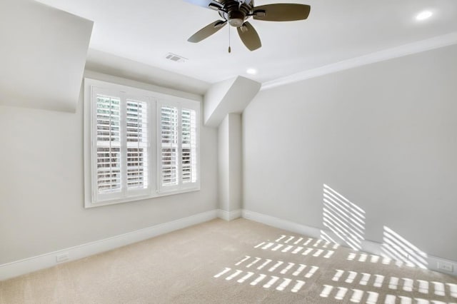 spare room featuring baseboards, visible vents, a ceiling fan, light colored carpet, and recessed lighting