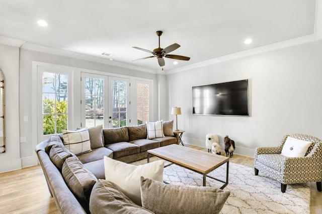 living area featuring light wood-style flooring, recessed lighting, visible vents, baseboards, and ornamental molding