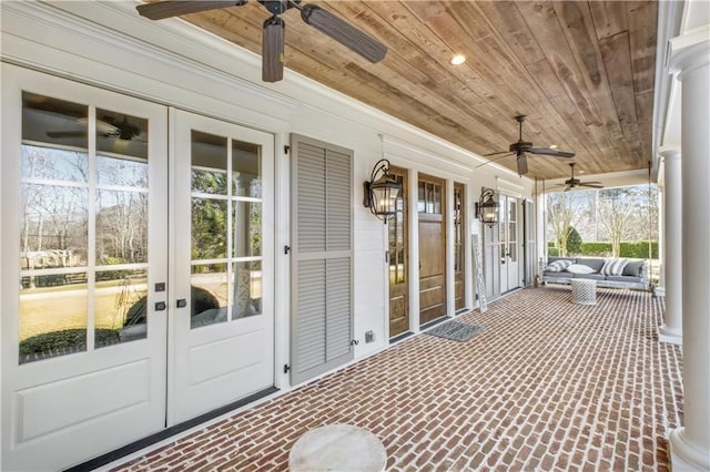 exterior space featuring wood ceiling and a ceiling fan