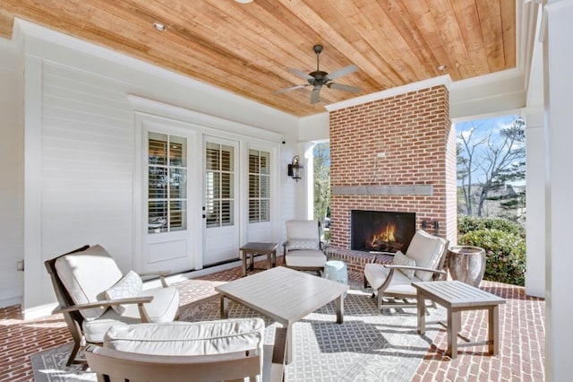 view of patio / terrace featuring an outdoor brick fireplace and a ceiling fan