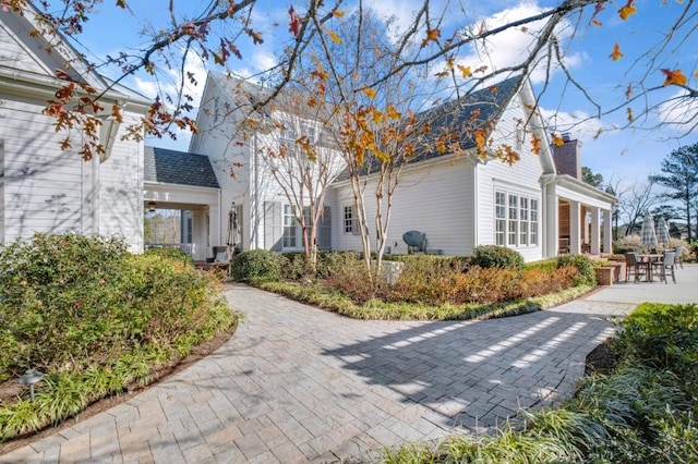 exterior space with a patio and a chimney