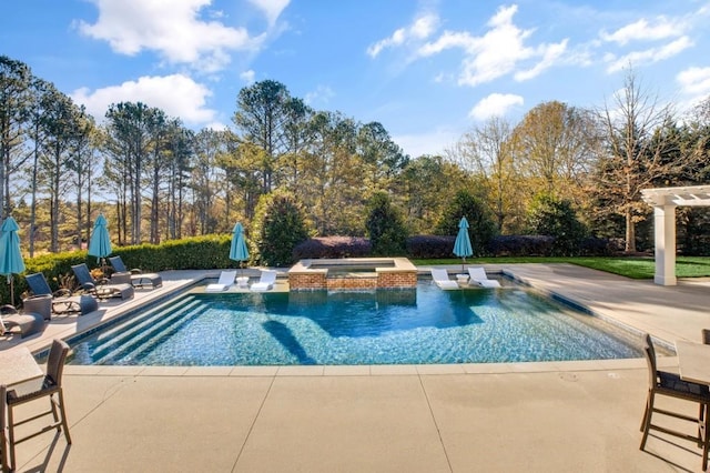 outdoor pool with a patio area and an in ground hot tub