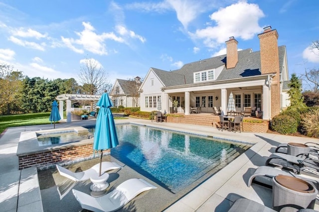 rear view of house featuring a patio, an in ground hot tub, french doors, an outdoor pool, and a pergola