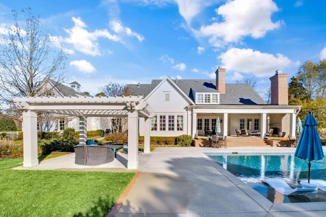 rear view of house with an outdoor pool, french doors, a yard, a patio area, and a pergola