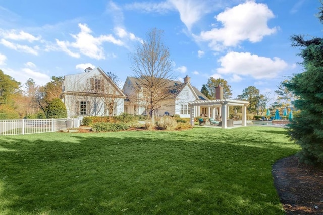 view of yard featuring fence and a pergola