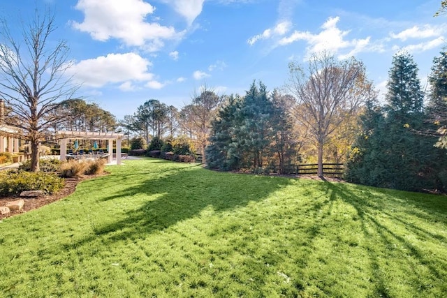 view of yard featuring fence and a pergola