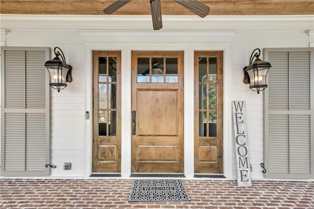 view of exterior entry featuring ceiling fan