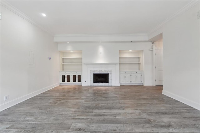3636 Peachtree Rd NE Unit 405, Atlanta, GA 30319 - unfurnished living room with ornamental molding, built in features, wood finished floors, a fireplace, and recessed lighting