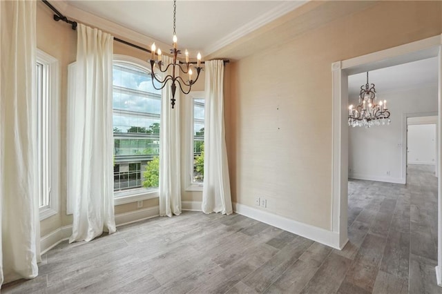 3636 Peachtree Rd NE Unit 405, Atlanta, GA 30319 - unfurnished dining area with a chandelier, wood finished floors, and ornamental molding