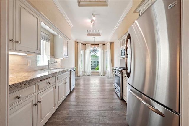 3636 Peachtree Rd NE Unit 405, Atlanta, GA 30319 - kitchen with appliances with stainless steel finishes, crown molding, decorative backsplash, dark wood-type flooring, and a chandelier