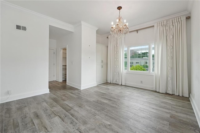 3636 Peachtree Rd NE Unit 405, Atlanta, GA 30319 - empty room featuring a chandelier, wood finished floors, and crown molding