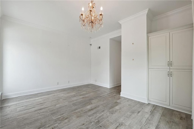3636 Peachtree Rd NE Unit 405, Atlanta, GA 30319 - empty room featuring a chandelier, light wood-style flooring, and ornamental molding