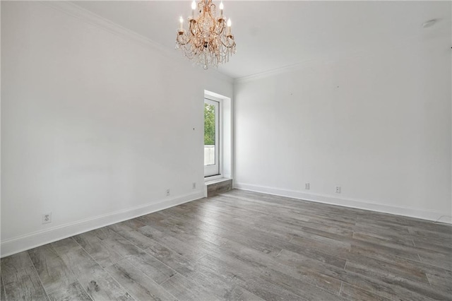 3636 Peachtree Rd NE Unit 405, Atlanta, GA 30319 - unfurnished room with a chandelier, ornamental molding, and wood finished floors