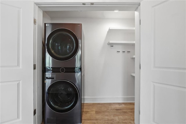 3636 Peachtree Rd NE Unit 405, Atlanta, GA 30319 - laundry area with stacked washer and clothes dryer and wood finished floors