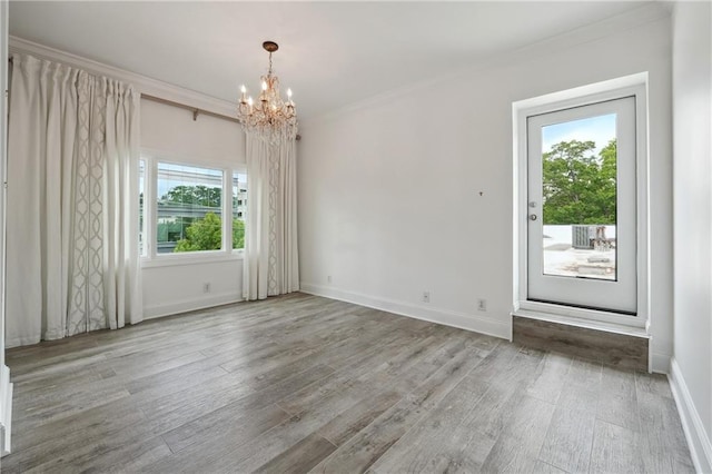 3636 Peachtree Rd NE Unit 405, Atlanta, GA 30319 - spare room featuring a chandelier, wood finished floors, and crown molding