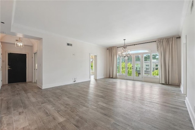 3636 Peachtree Rd NE Unit 405, Atlanta, GA 30319 - unfurnished living room with a chandelier, crown molding, and light wood-type flooring