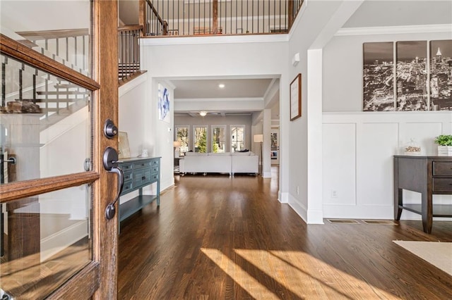 entryway with crown molding and dark hardwood / wood-style floors