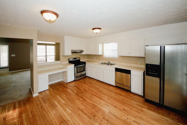 kitchen featuring white cabinetry, appliances with stainless steel finishes, sink, and light hardwood / wood-style floors