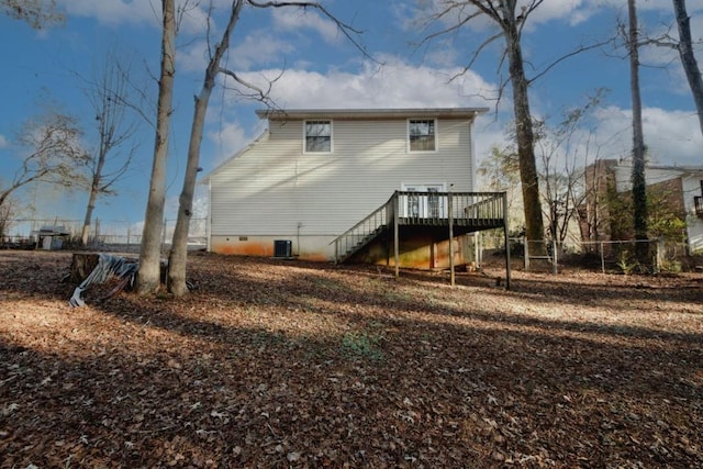 rear view of property featuring a deck and central air condition unit