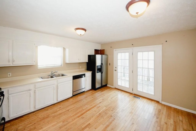 kitchen with white cabinetry, appliances with stainless steel finishes, sink, and plenty of natural light