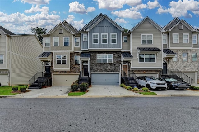 2719 Hedgeway Cir, Kennesaw, GA 30144 - townhome / multi-family property featuring stone siding, driveway, board and batten siding, an attached garage, and stairs