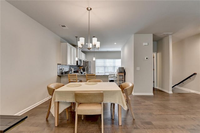2719 Hedgeway Cir, Kennesaw, GA 30144 - dining room featuring a chandelier and dark wood-style flooring