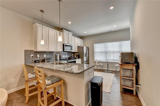 2719 Hedgeway Cir, Kennesaw, GA 30144 - kitchen with appliances with stainless steel finishes, light stone counters, decorative backsplash, dark wood-type flooring, and recessed lighting