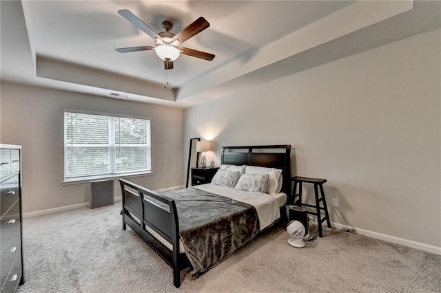 2719 Hedgeway Cir, Kennesaw, GA 30144 - bedroom featuring a tray ceiling, carpet flooring, and a ceiling fan