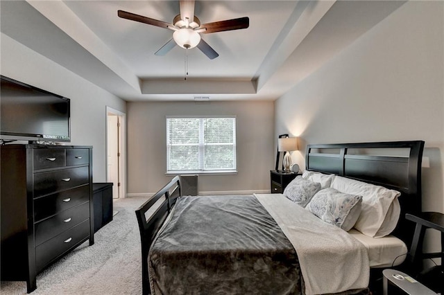 2719 Hedgeway Cir, Kennesaw, GA 30144 - carpeted bedroom with a tray ceiling and a ceiling fan