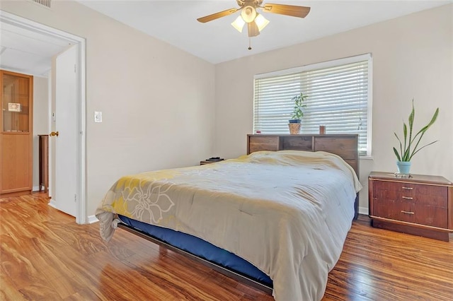 bedroom with hardwood / wood-style floors and ceiling fan