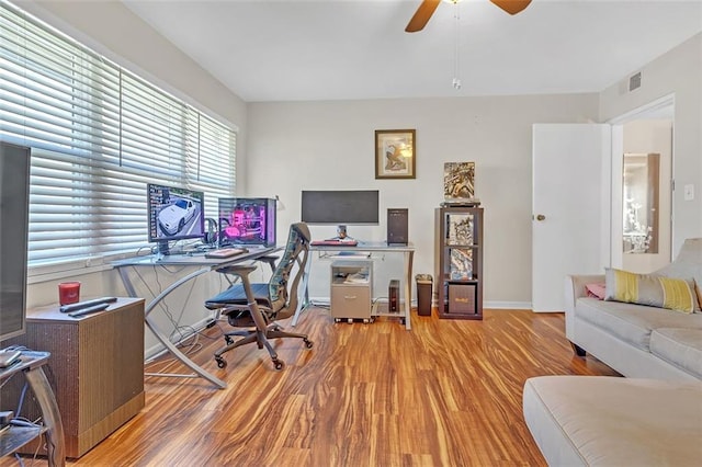 office space with ceiling fan and light hardwood / wood-style floors