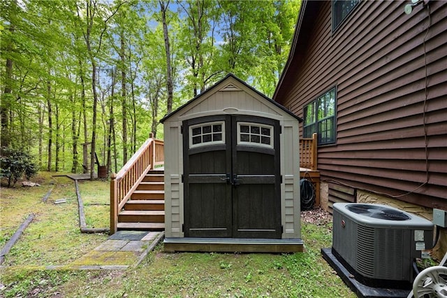 view of shed featuring cooling unit and stairs