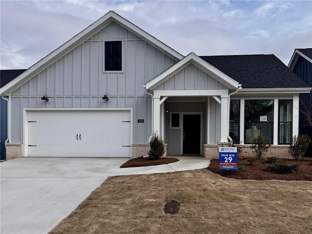 view of front of property with a yard and a garage