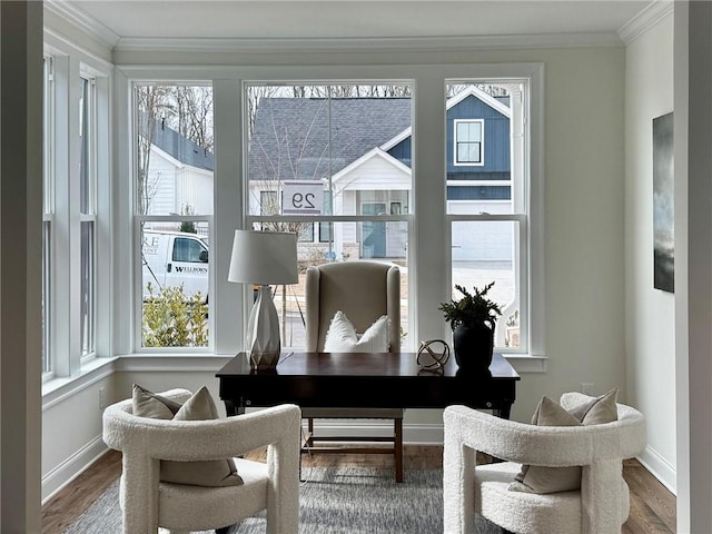 living room with a wealth of natural light, hardwood / wood-style flooring, and ornamental molding