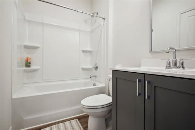 bathroom with shower / bath combination, toilet, wood finished floors, and vanity