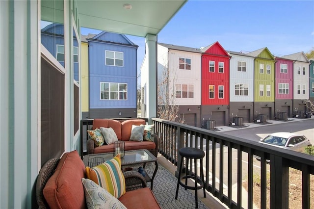 balcony featuring a residential view, central AC, and an outdoor hangout area