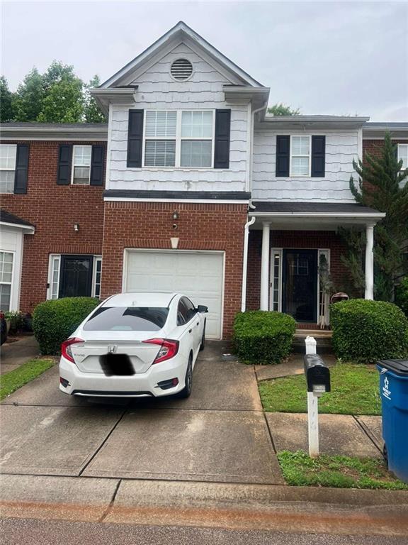 116 Madeline Ct, Mcdonough, GA 30253 - townhome / multi-family property featuring brick siding, concrete driveway, and a garage