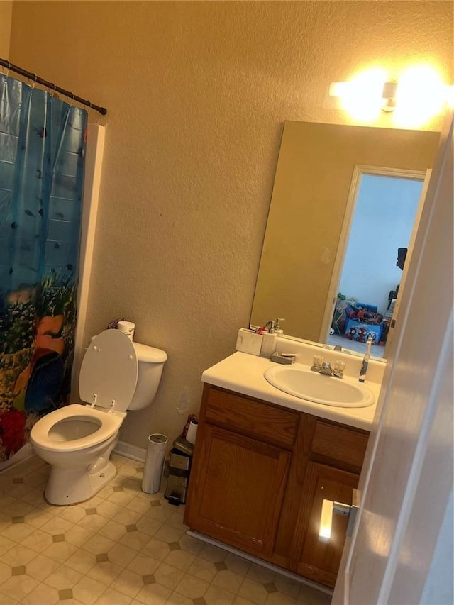 116 Madeline Ct, Mcdonough, GA 30253 - bathroom featuring a textured wall, toilet, vanity, tile patterned floors, and a shower with shower curtain