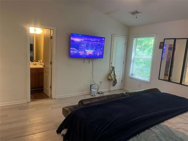 116 Madeline Ct, Mcdonough, GA 30253 - bedroom featuring wood finished floors, baseboards, vaulted ceiling, connected bathroom, and a sink