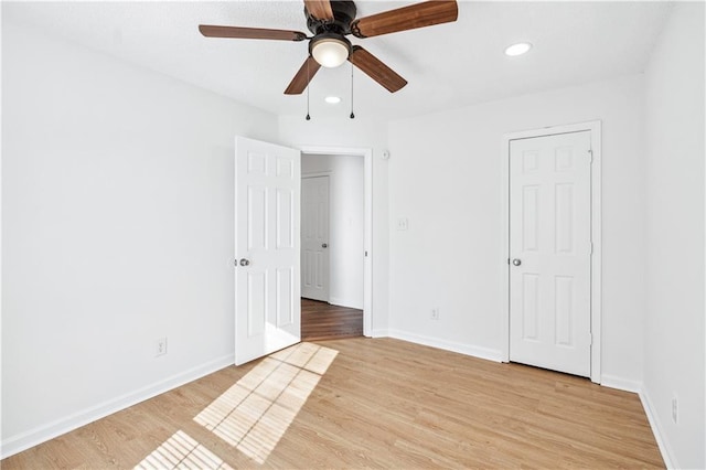 unfurnished bedroom with light wood-type flooring, baseboards, a ceiling fan, and recessed lighting